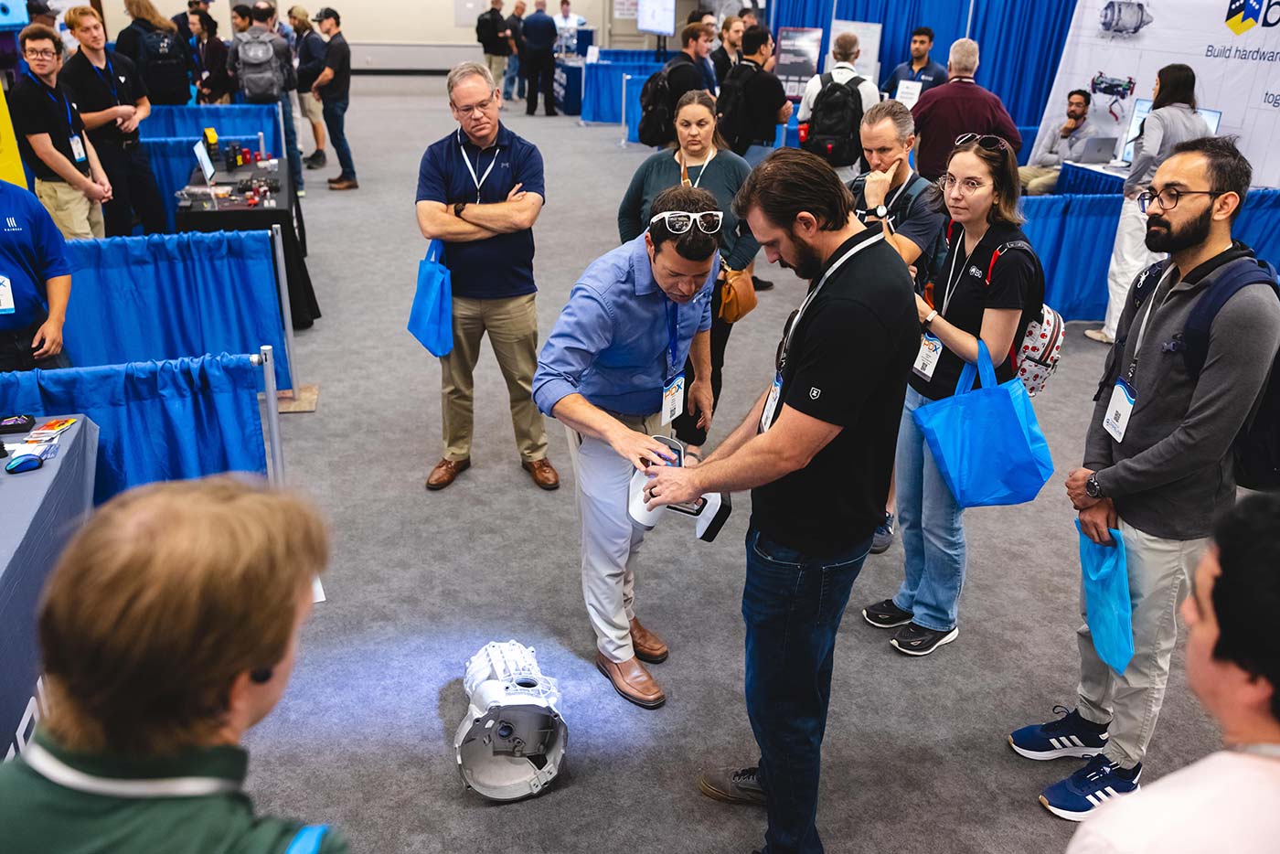 Engineers gathered around a hardware demonstration
